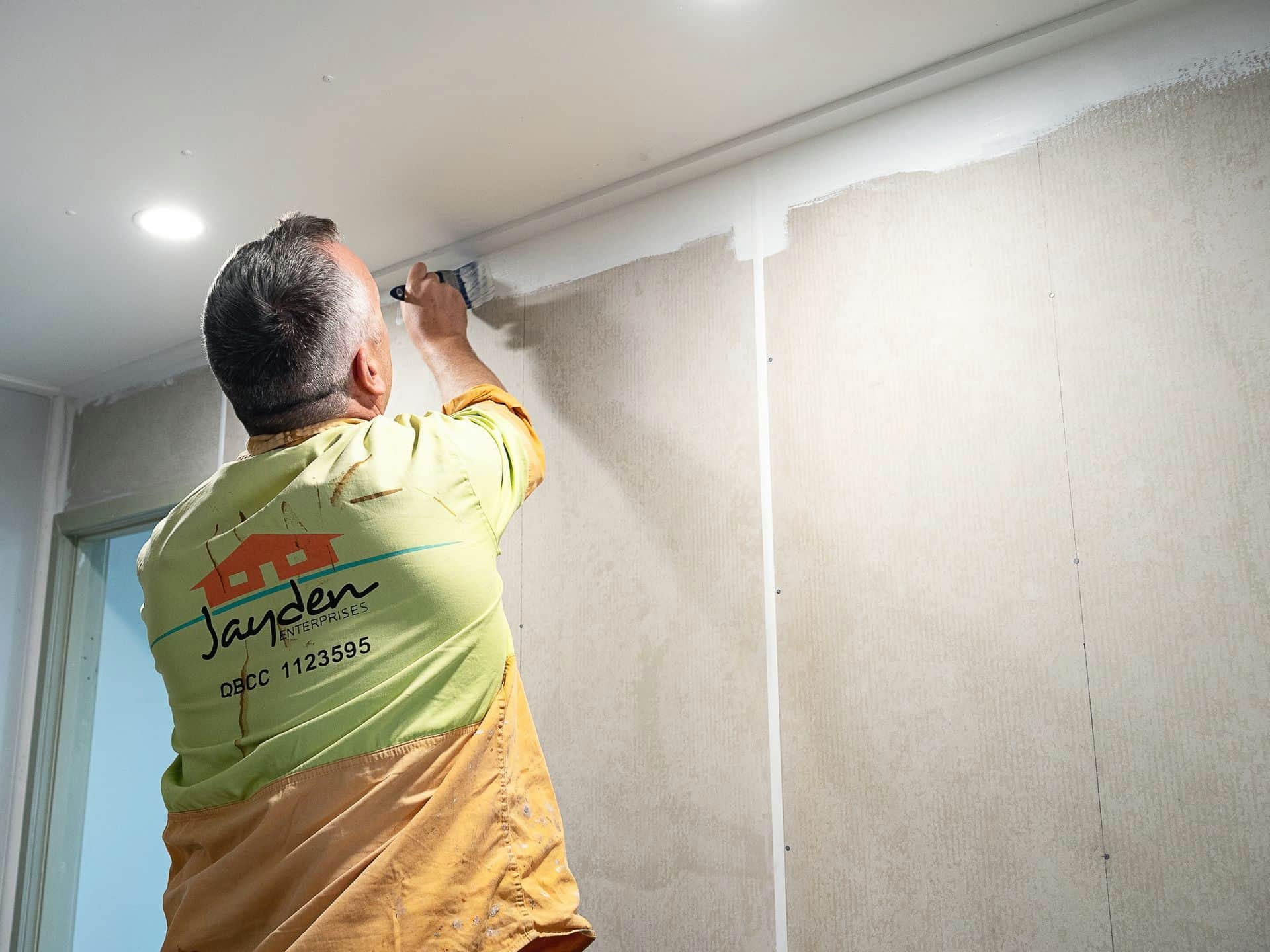 Tradesman Painting a Wall — Jayden Enterprises in Mackay, QLD