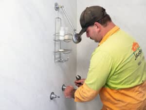 Man Doing Plumbing Maintenance in Bathroom