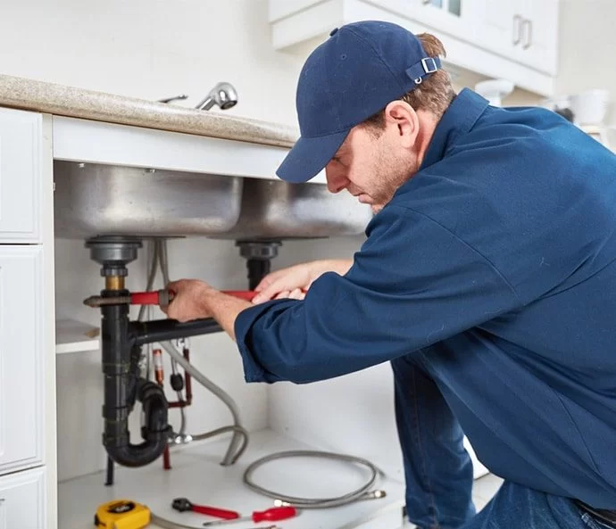 Jaden Enterprises Plumber working under the sink