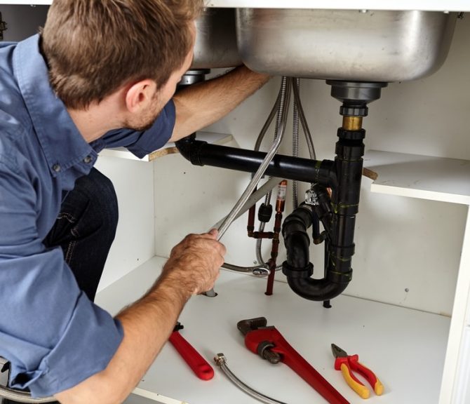 Plumber Repairing Kitchen Sink — Jayden Enterprises in Mackay, QLD